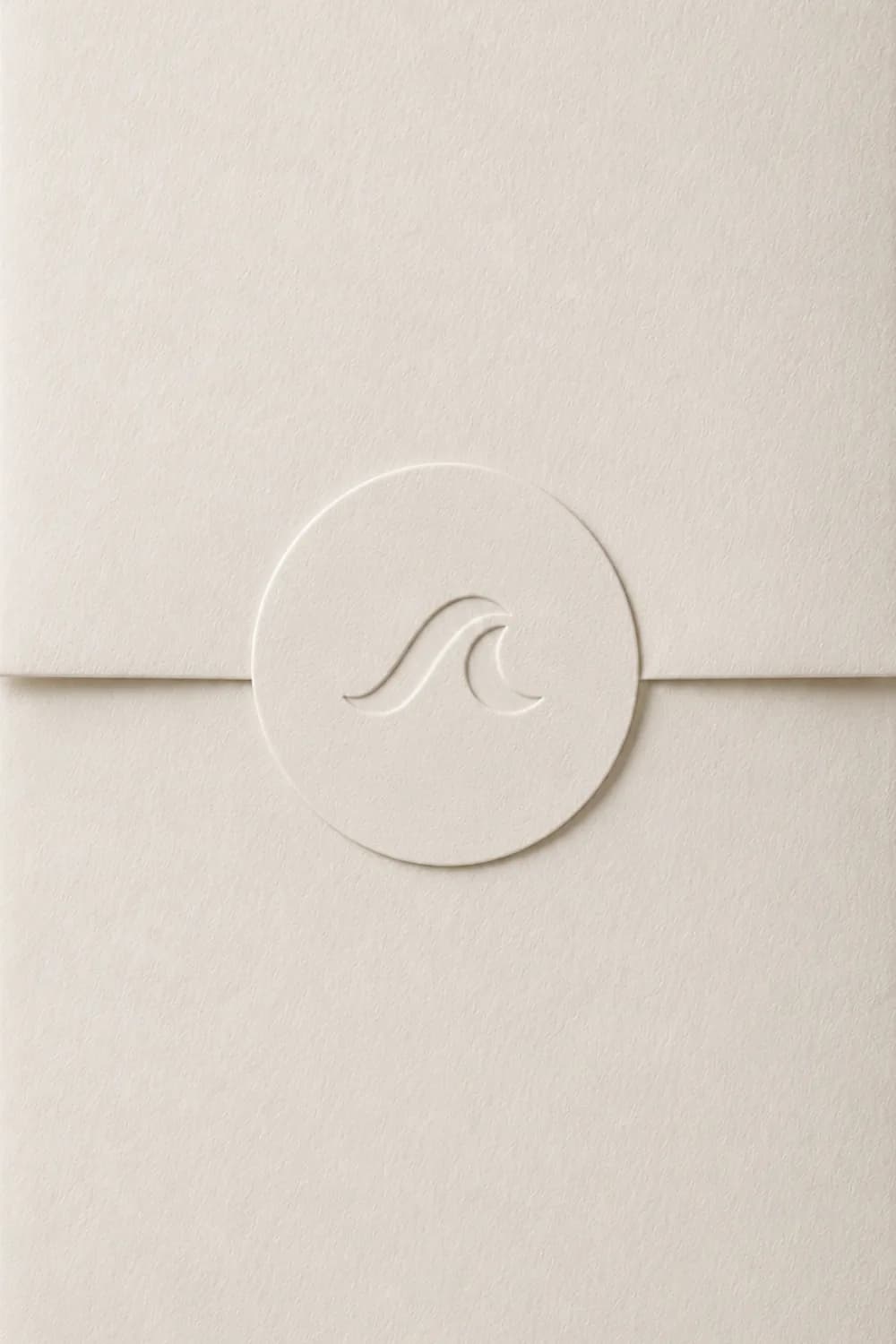 An embossed wave emblem pressed into a cream paper seal
