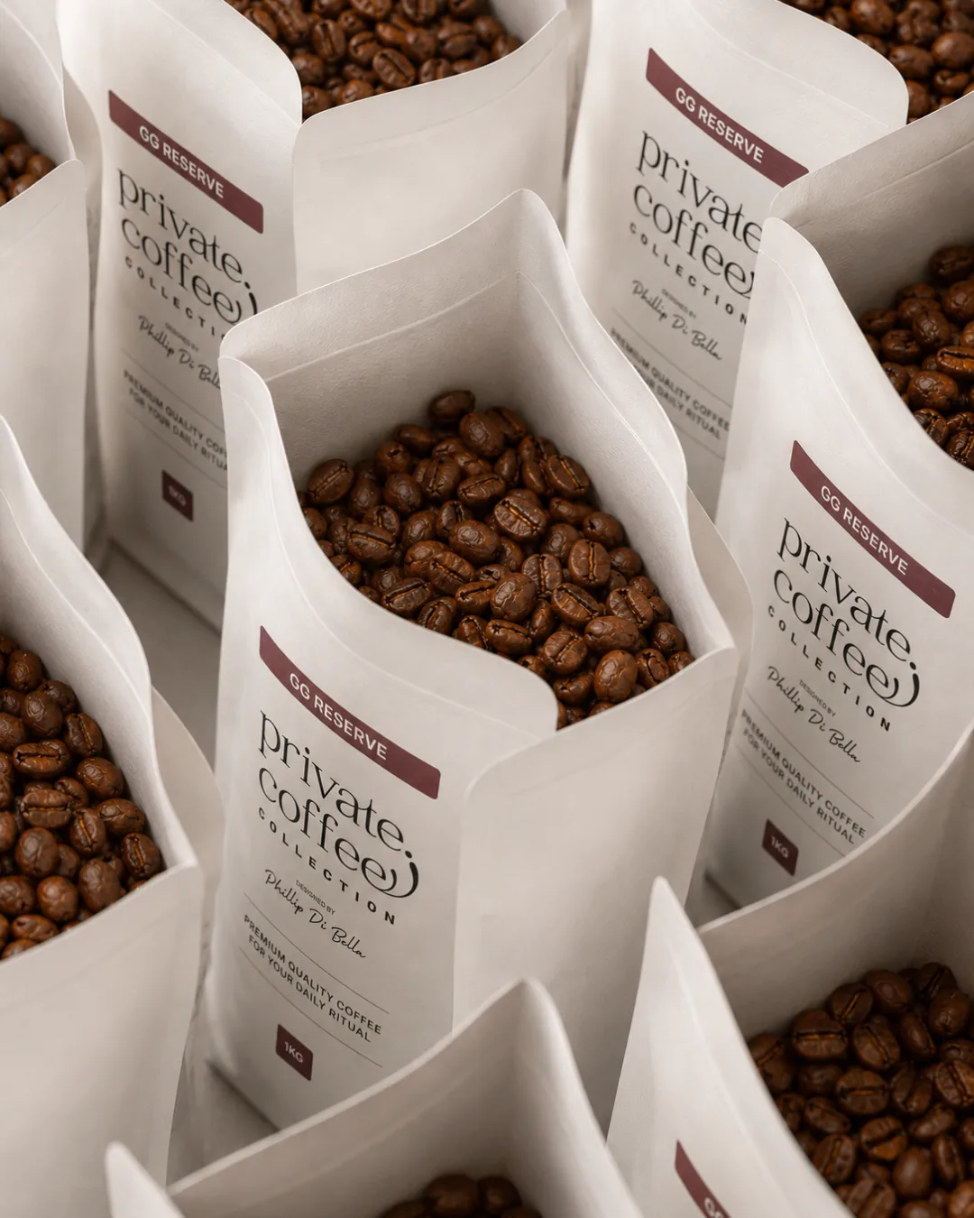 Rows of Private Coffee Collection GG Reserve bags open and filled with fresh roasted beans
